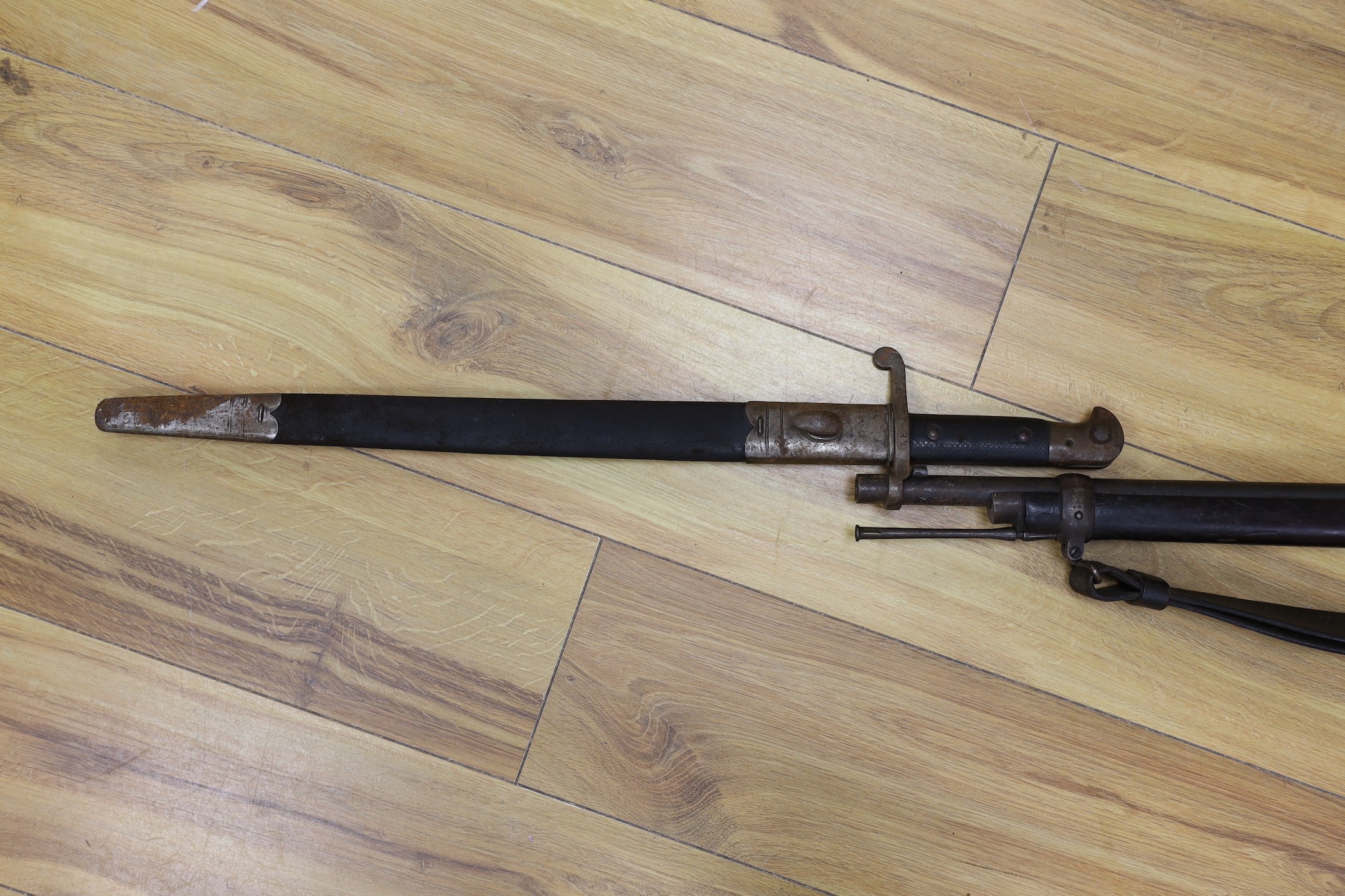 An Enfield breech loading .577 calibre rifle dated 1886, with Wilkinson bayonet and sheath